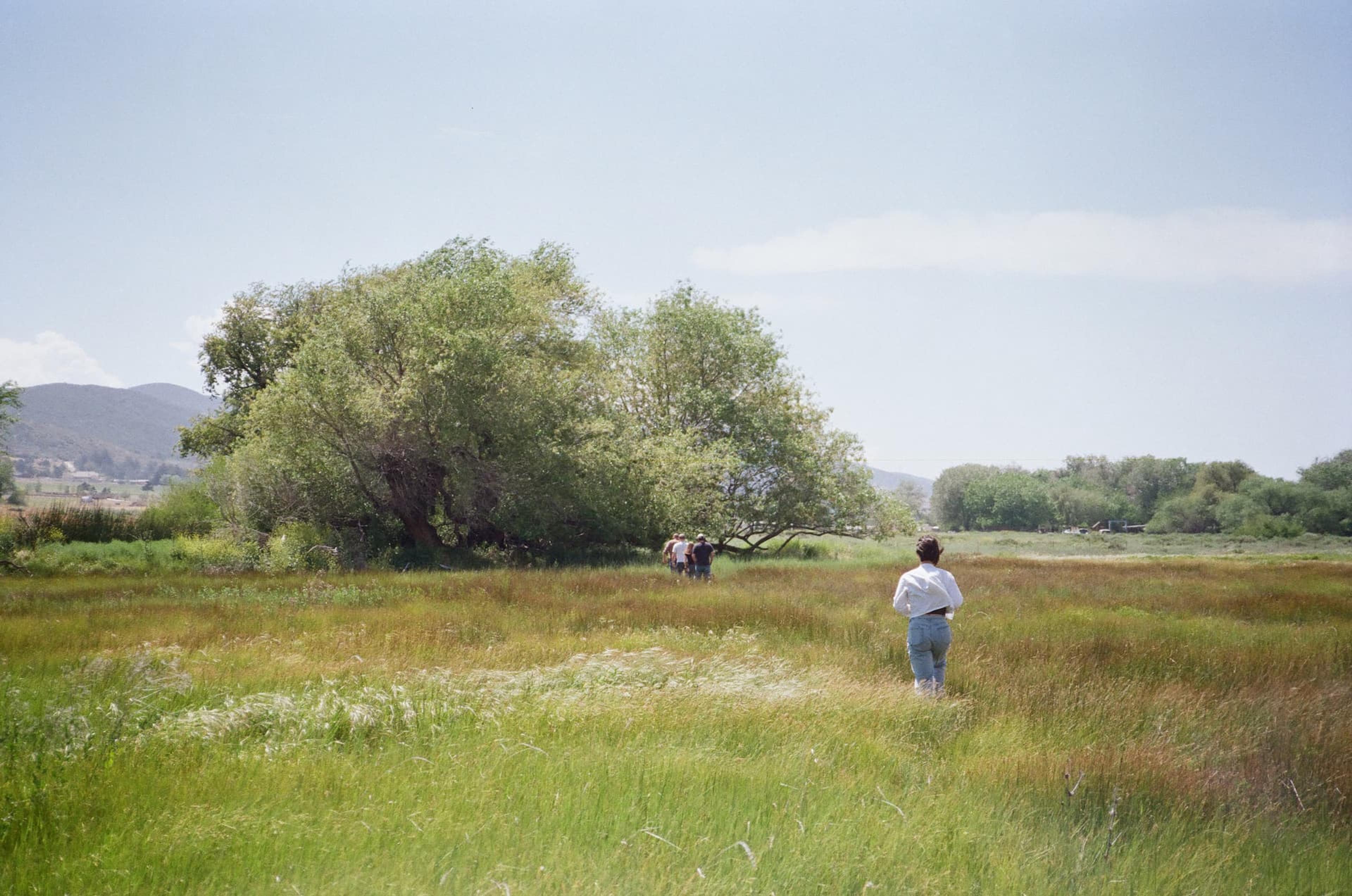 Maika walking through a field with one of our customers.